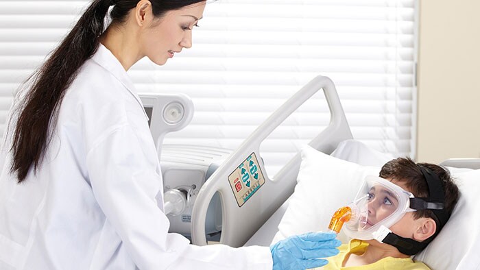 clinician placing respiratory mask on a child's face