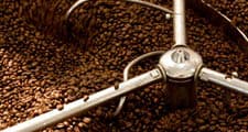 The green coffee beans are roasted to achieve the desired flavour