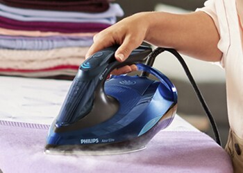 A Philips Steam Iron being used on clothes
