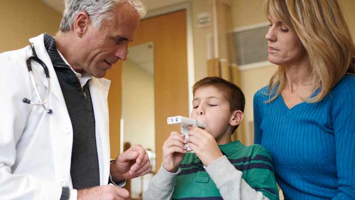 Healthcare professional helping kid with asthma product