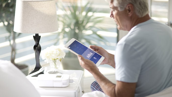 Philips CPAP man holding tablet