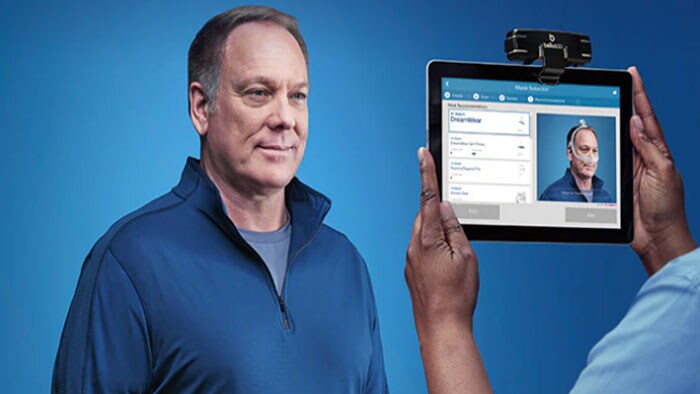 Philips CPAP man holding tablet