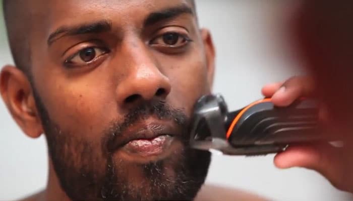 Man trimming his beard before shaving a soul patch